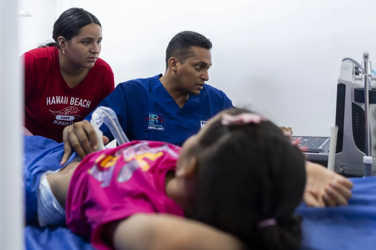medical staffer performing ultrasound on young girl in Colombia