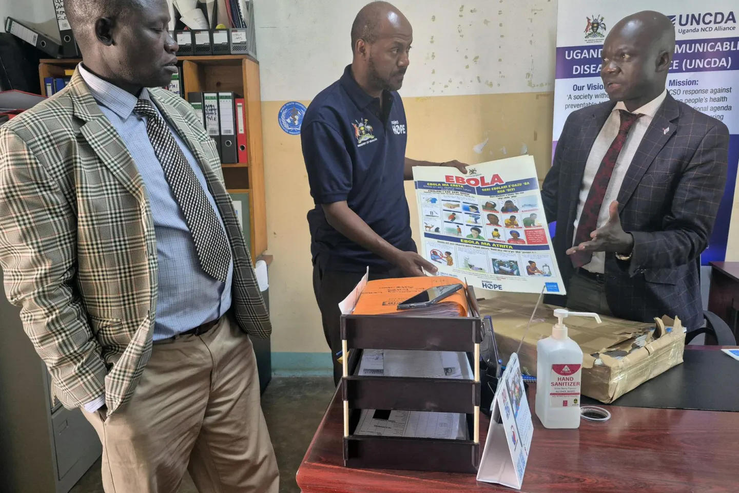 man shares information on Ebola to two other men