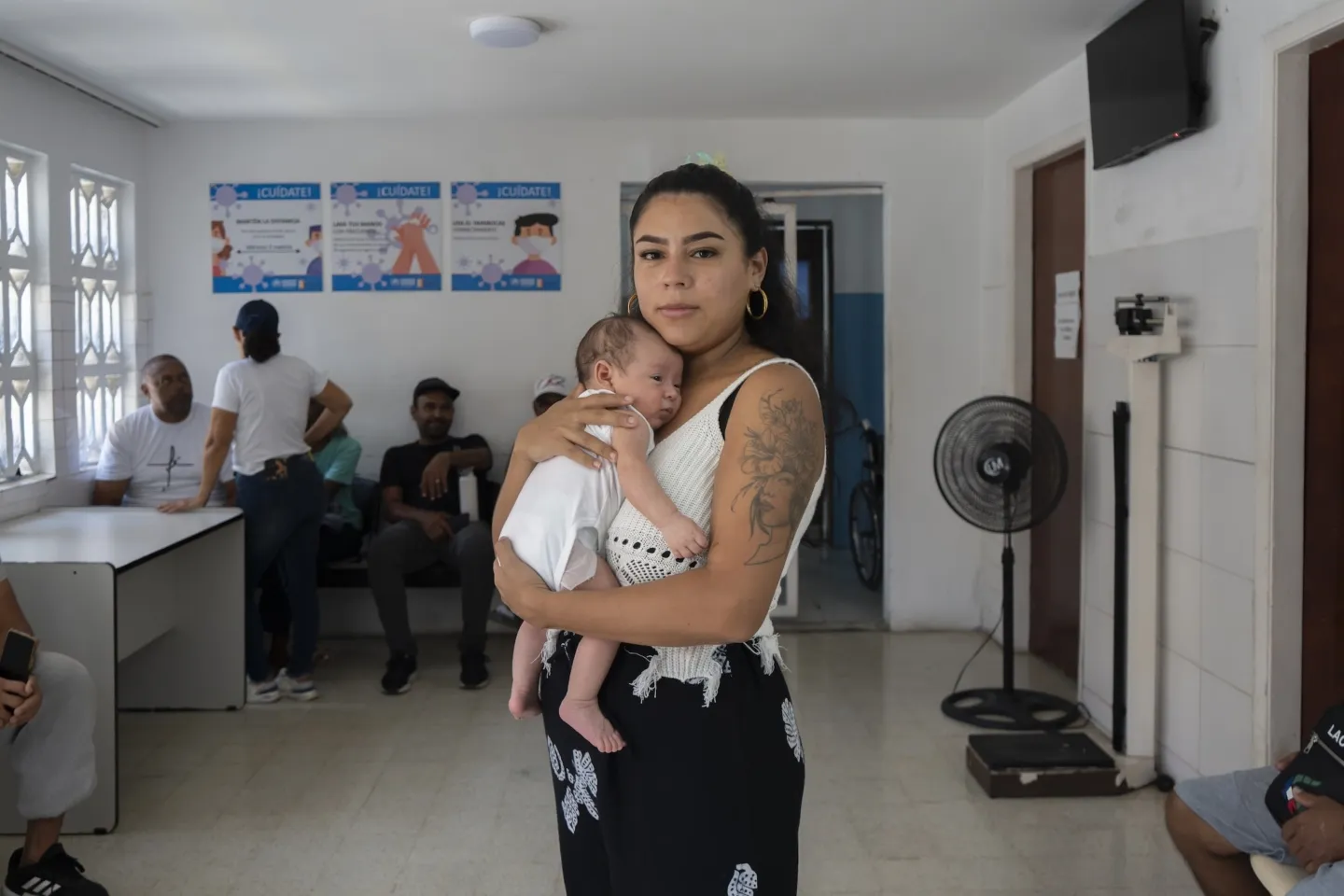 new mother holds newborn inside medical clinic in Venezuela